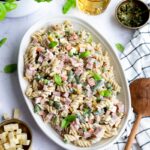 Salade de pâtes au jambon et légumes colorés déposée dans un bol blanc de forma ovale